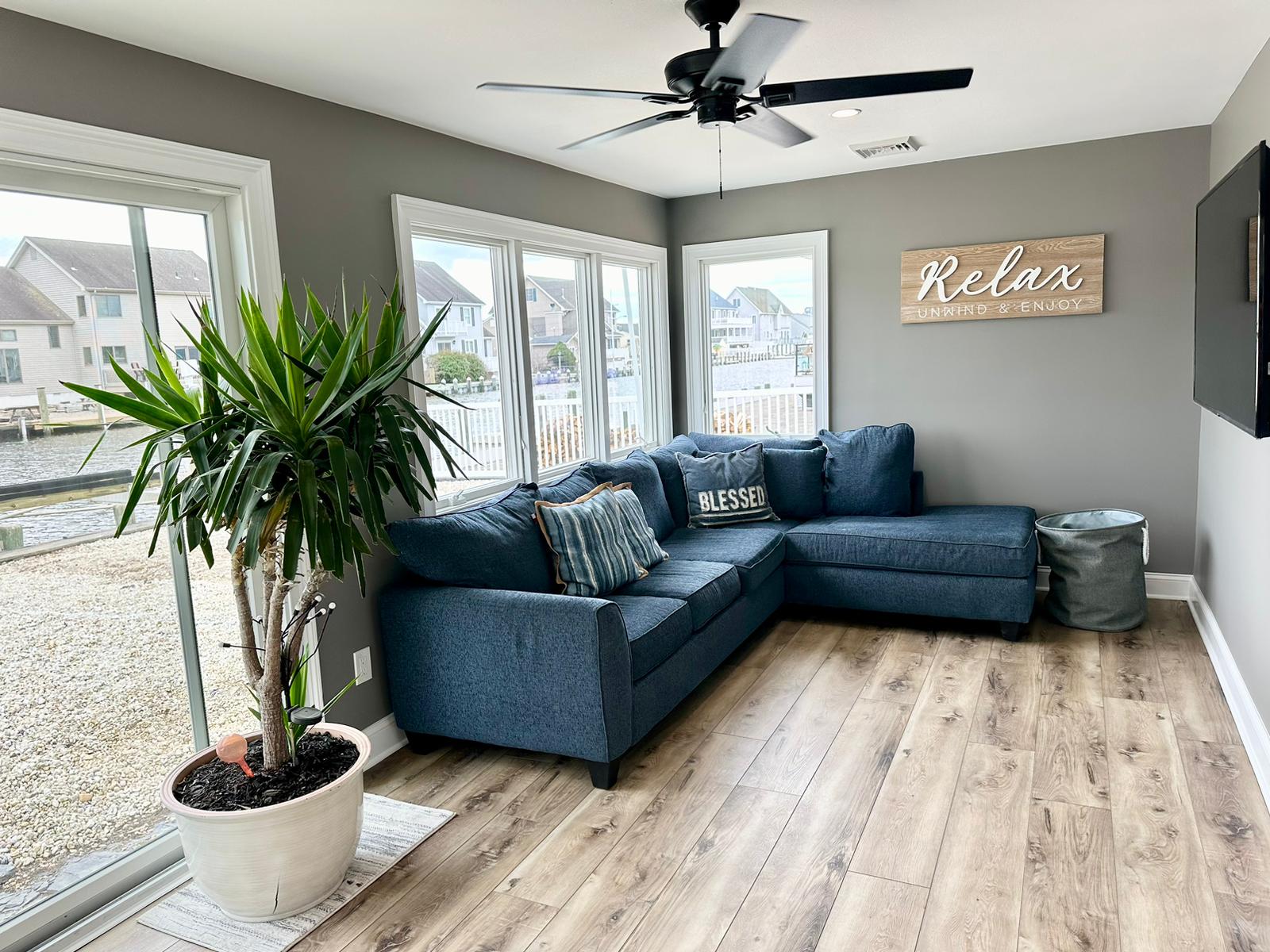 Living room repainted from bright teal to a soft warm gray — after